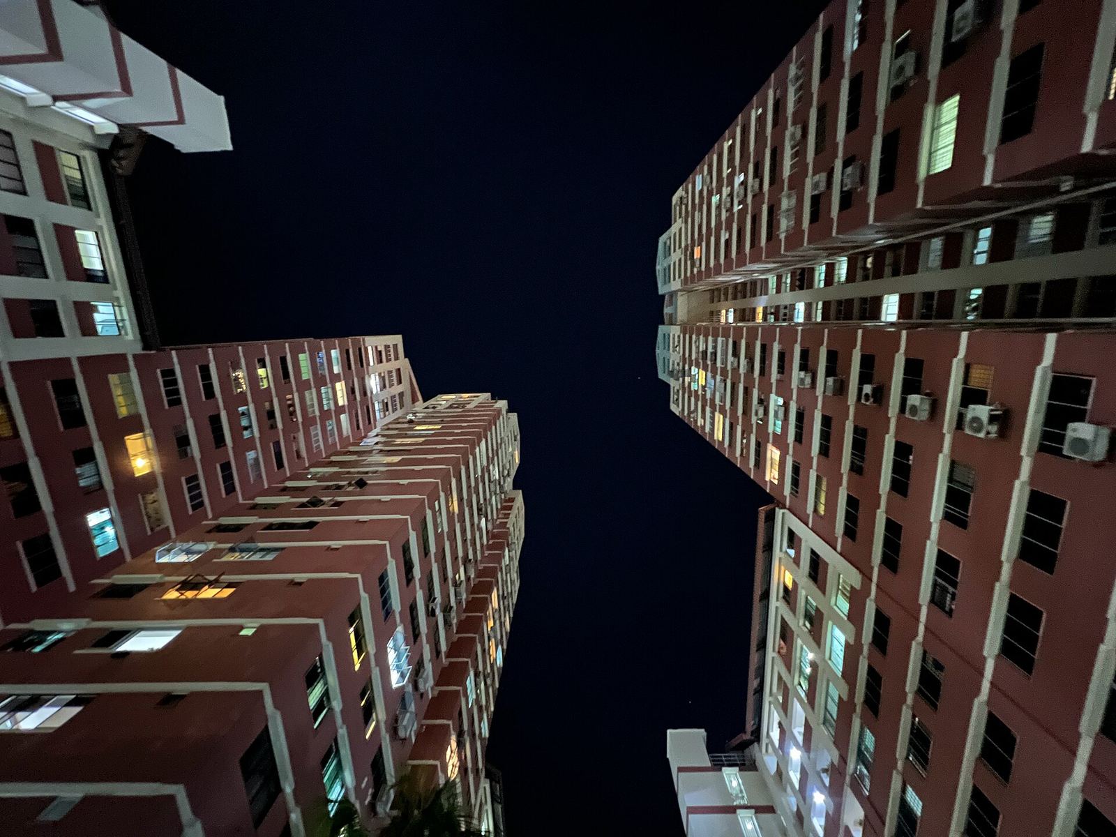 HDB blocks at Sin Ming Court at night, a few windows lit.